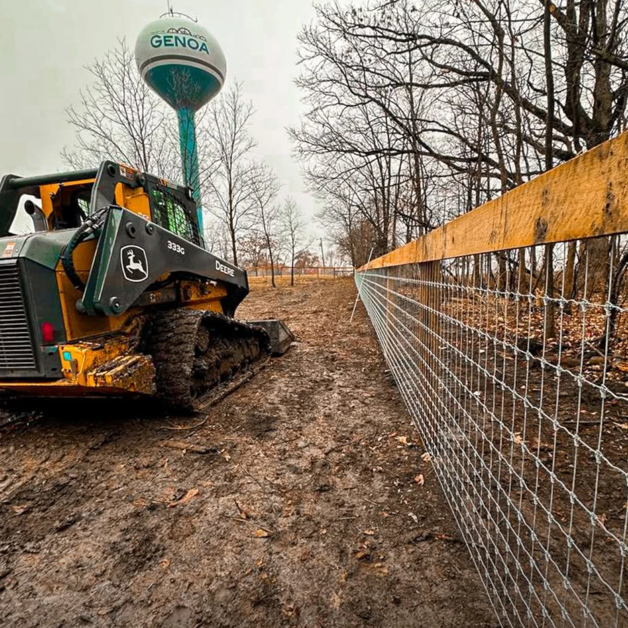 Farm fence installation beside an agricultural field