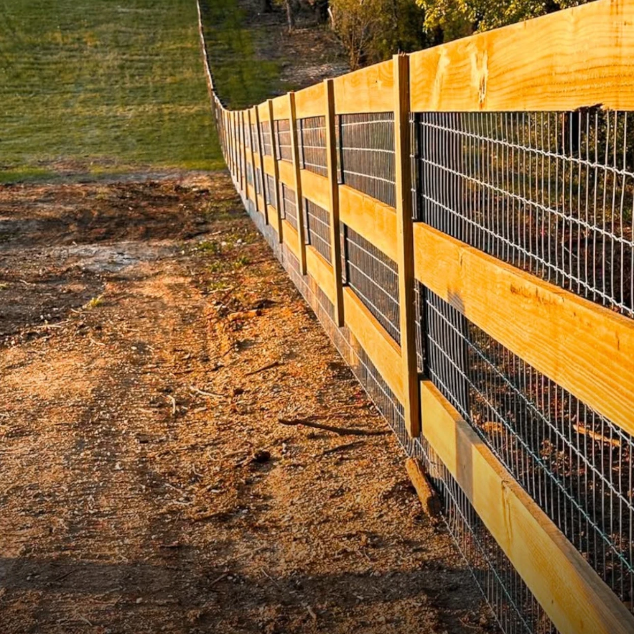 Woven-wire farm fence installed along a rural property
