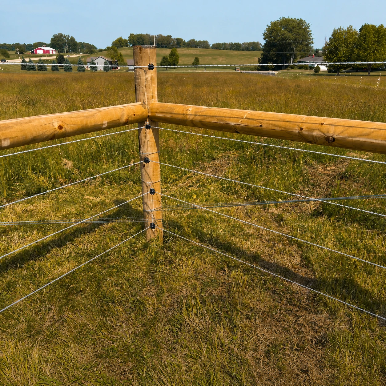 Completed high-tensile farm fence on a rural property