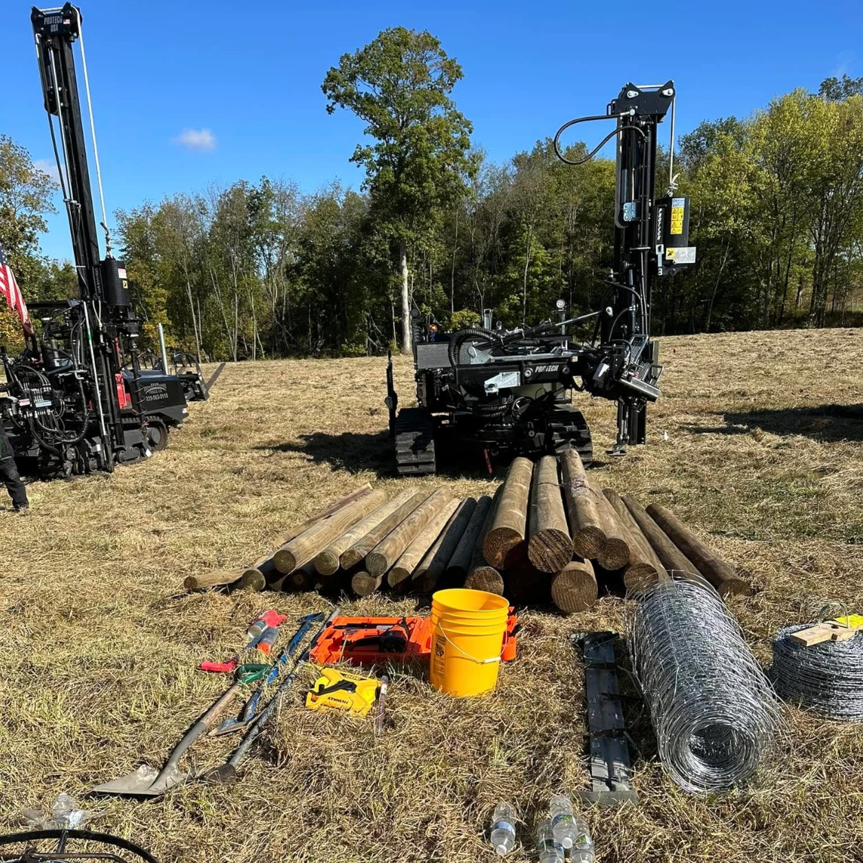 Fence installation equipment, wooden posts, and wire prepared at a rural property