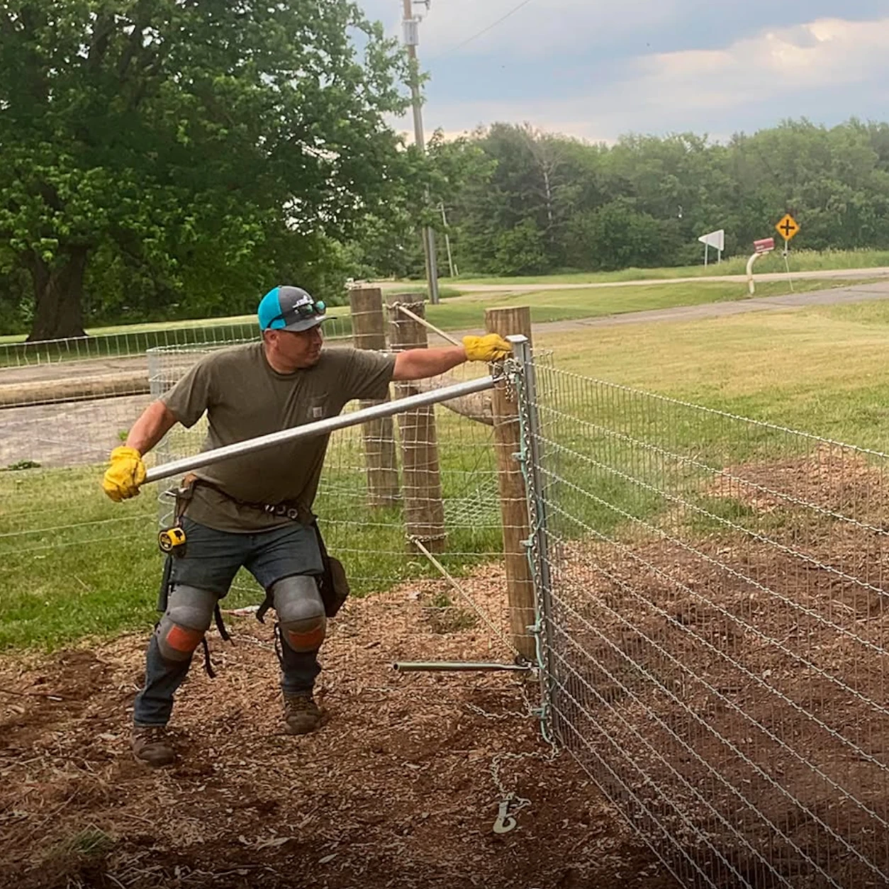Pasture fence installation with woven wire and livestock access gate