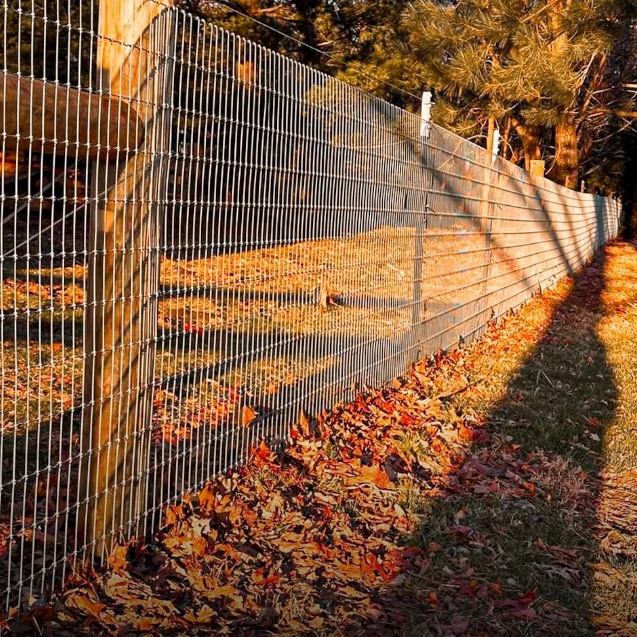 Farm fencing contractor installing woven-wire fencing in the Chicago area